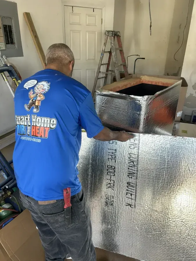 Smart Home Air and Heat certified technician installing a new heating system ductwork in an Orlando home